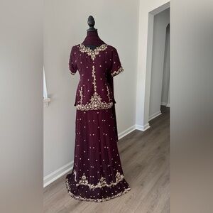 Burgundy Lengha with gold hand work.  Good for wedding reception parties..